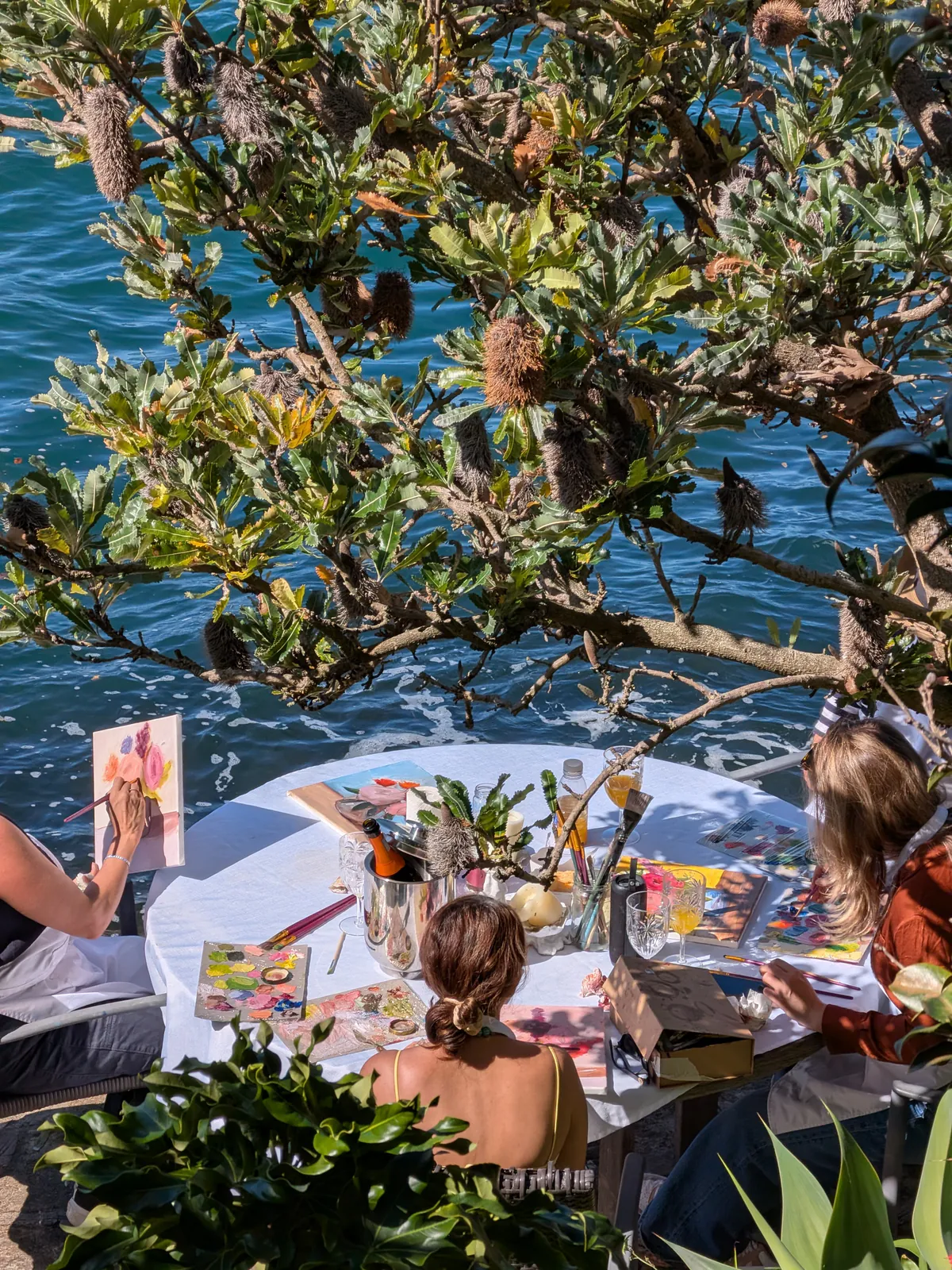 A table set for high tea and painting beside the harbour